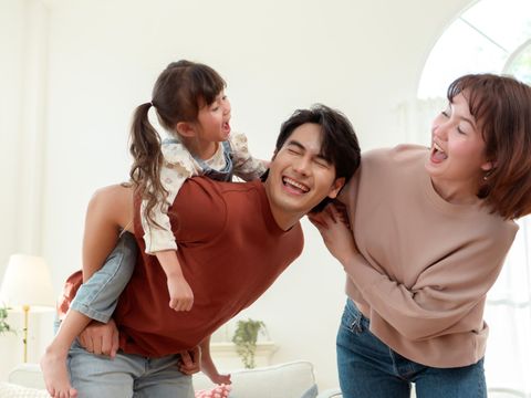 Family playing together at home while their cleaning is taken care of