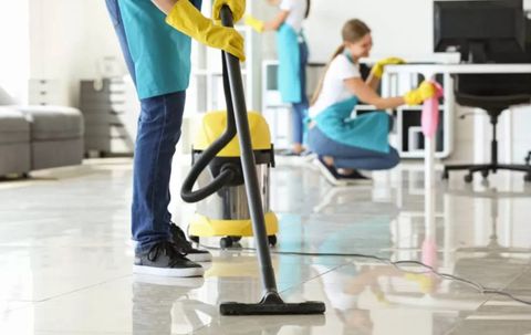 Blueseven cleaning team vacuuming and wiping surfaces, representative of teams working in York
